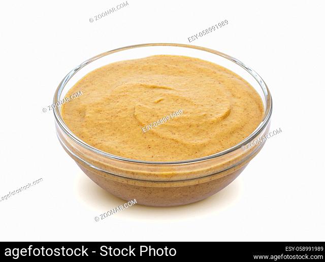 Mustard in bowl isolated on white background with clipping path