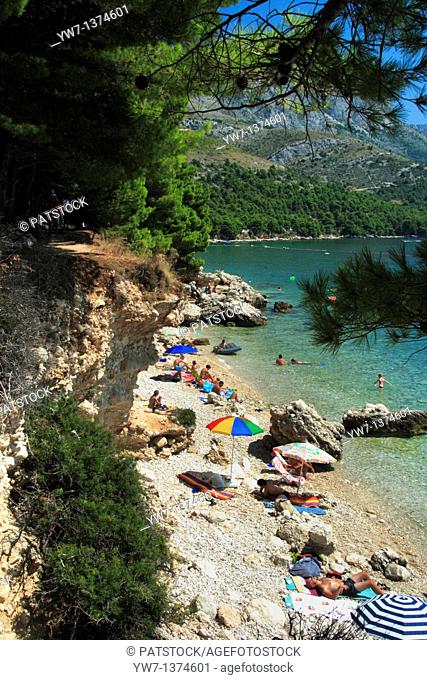 Tourists enjoying their time at a beach in Zivogosce village, Croatia
