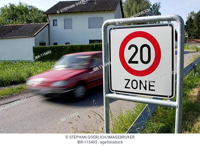 Markt Schwaben, GER, 26. June 2006 - A car passes a sign which marks the begin of a speed limited zone in Markt Schwaben Bavaria Germany