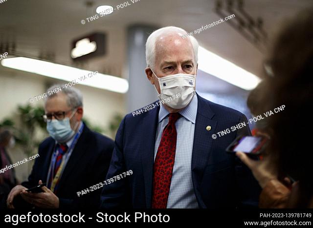 Senator John Cornyn, a Republican from Texas, wears a protective mask while talking with members of the press in the Senate Subway at the U.S