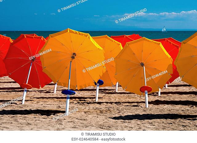 Colorful umbrellas on sandy beach in Lignano Sabbiadoro, Italy, Europe