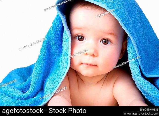 Cute eight month old baby wrapped in a towel isolated on white background