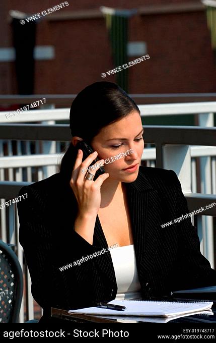 A young attractive female business professional on a cell phone