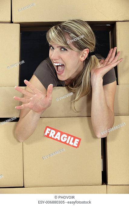 Woman surrounded by moving boxes