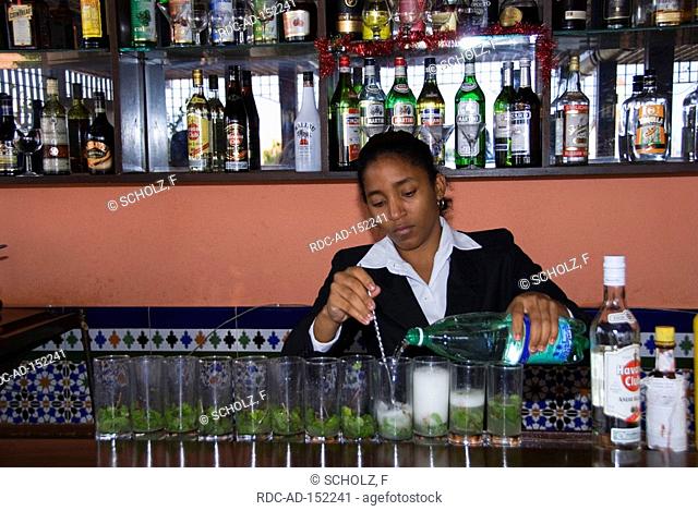 Woman in bar preparation of a Mojito Hotel Ambos Mundos Havana Cuba barkeeper