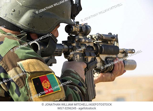 AFGHANISTAN Helmand Province -- 02 Feb 2013 -- An Afghan Commando from 3rd Company, 7th Special Operations Kandak engages range targets with an M4 rifle in...