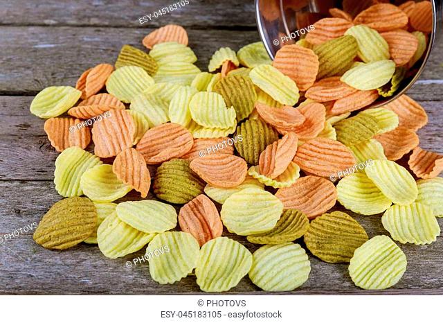 Corn chips with sauce on wooden table. Selective focus closeup of a pile of appetizing corn chips