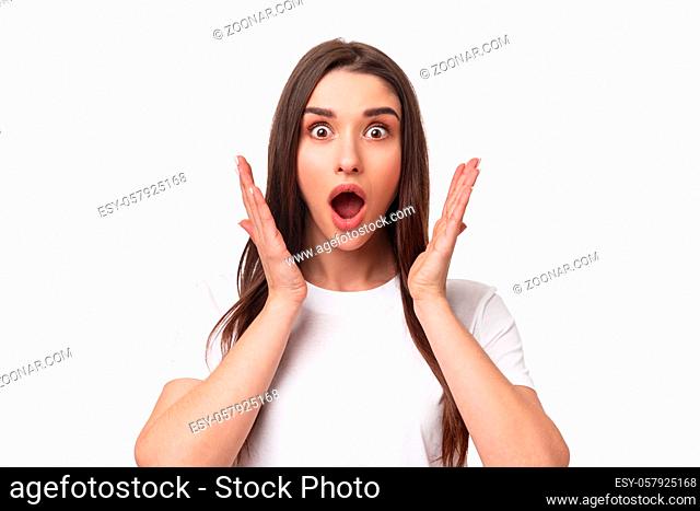 What an amazing news. Surprised and astonished, excited young woman react to something awesome happened, gasping, open mouth and raise hands near face