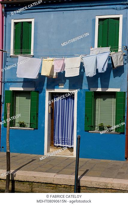 Clothes on a clothesline on frontage of the colorful houses in the village