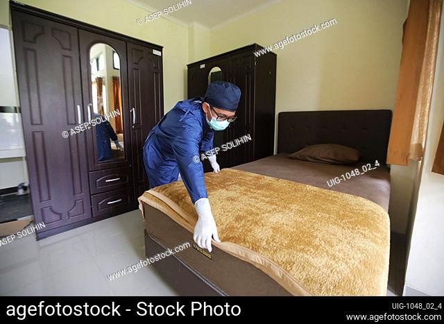 A worker cleaning in a room, at a Quarantine Shelter Home, Bandung Regency, Indonesia, during COVID-19 pandemic, on June 6, 2020