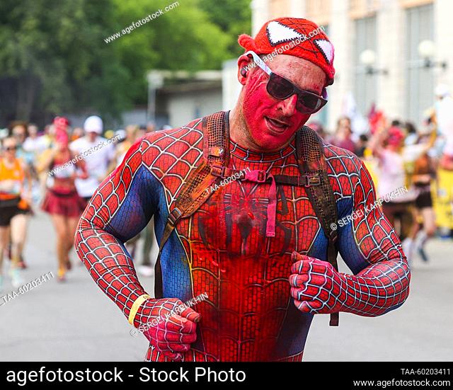 RUSSIA, MOSCOW - JULY 2, 2023: A runner dressed up as Spiderman is seen during Colourful Run in Luzhniki. The route of the 5km race runs around the Luzhniki...