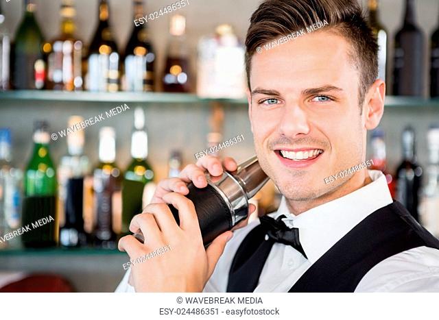 Waiter shaking cocktail