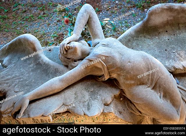GENOA, ITALY - June 2020: antique statue of angel (1910, marble) in a Christian Catholic cemetery - Italy