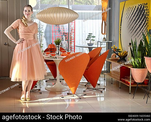 Portrait of vintage styled woman standing the kitchen of her mid-century styled home