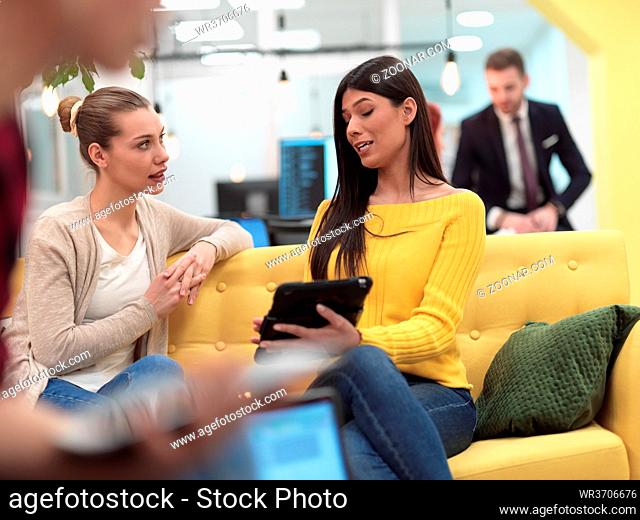 group of female friends having a team meeting and discussion about project or gossip chatting in modern startup business open space coworking office
