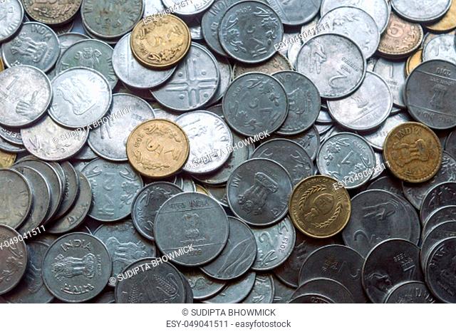 Stock pile of Hundred number 1, 10, 5 Indian rupee metal coin currency on isolated background. Financial, economy, investment concept