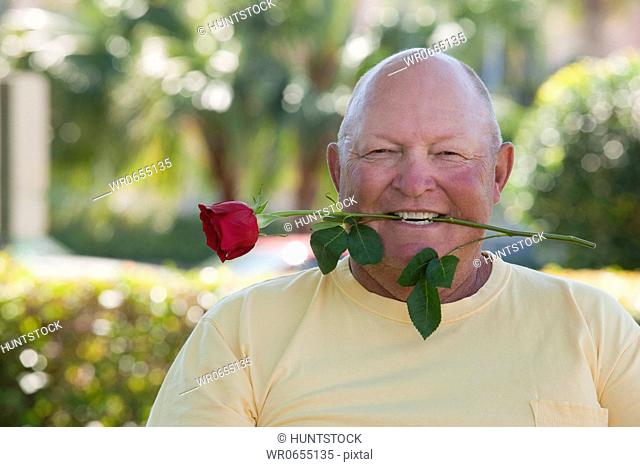 Man with a rose in his mouth