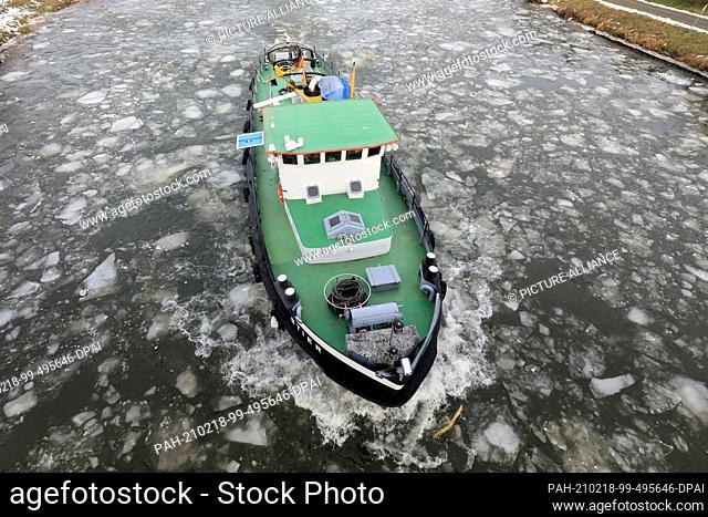 18 February 2021, Saxony-Anhalt, Calvörde: The icebreaker Stier drives over the Mittelland Canal through the ice floes. The cold of the past few days had formed...