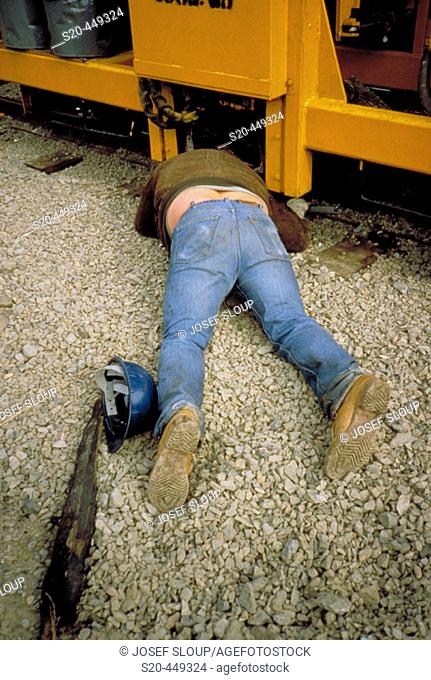 CPR (Canadian Pacific Railway) workers for tie gang which operates all over British Columbia, seasonal jobs in Canada. This man is trying to take out bent spike...
