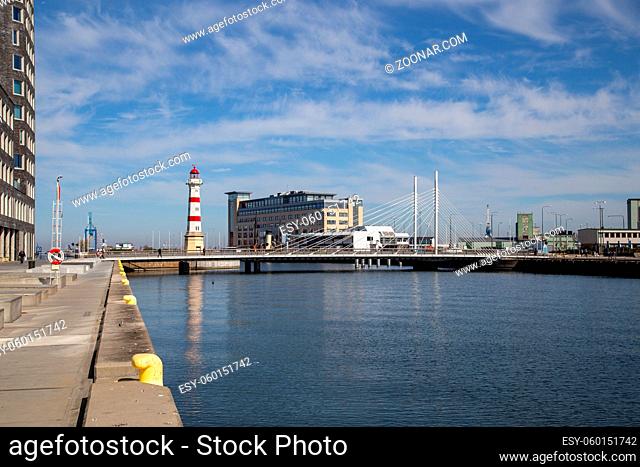 Malmo, Sweden - April 20, 2019: View of historic lighthouse and Univerisy Bridge in the harbour area