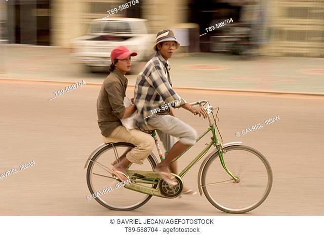 Girls on bicycle through the Siem Reap City