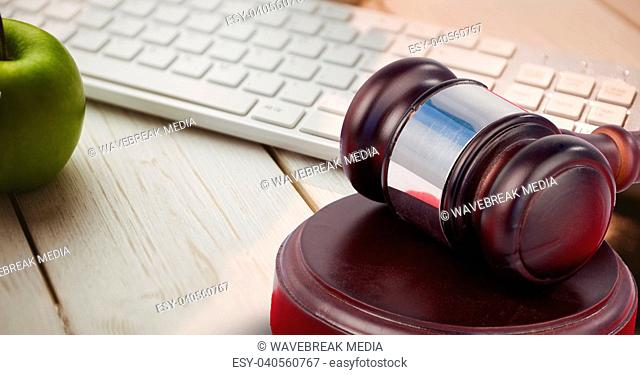 Gavel and keyboard with apple