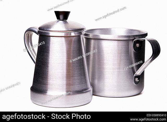 Close up view of an aluminum traditional tea cup and pot isolated on a white background