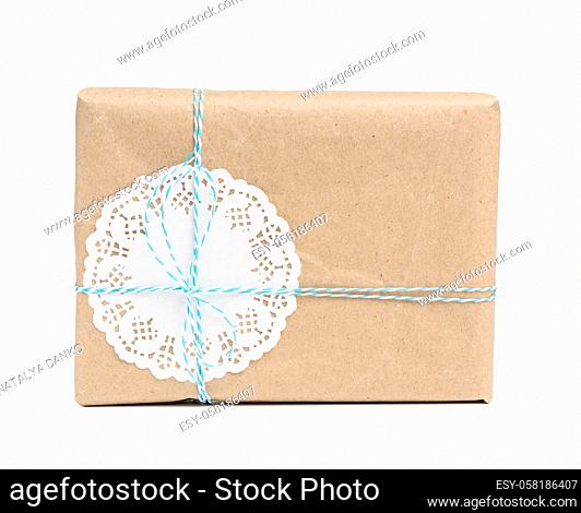 box wrapped in brown kraft paper and tied with blue rope, gift isolated on white background