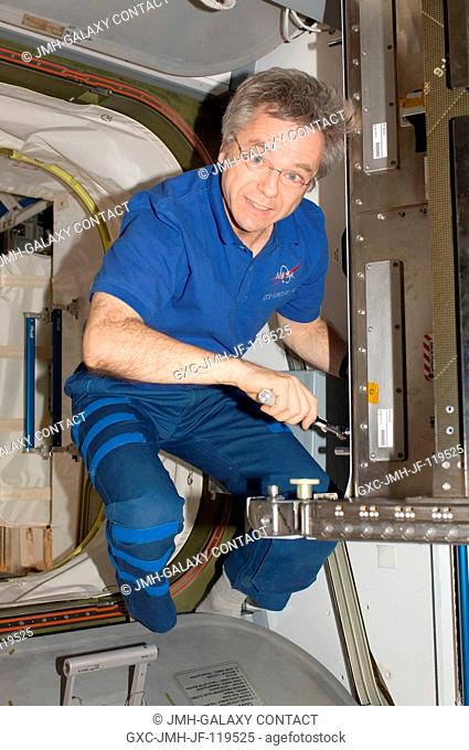 Canadian Space Agency astronaut Robert Thirsk, Expedition 20 flight engineer, performs in-flight maintenance (IFM) in the Harmony node of the International...