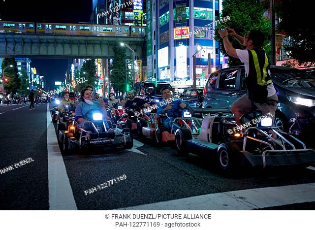 Picture with go-karts that resemble Mario Karts, but may not be called Mario Karts, on a street in Akihabara, in May 2019. | usage worldwide