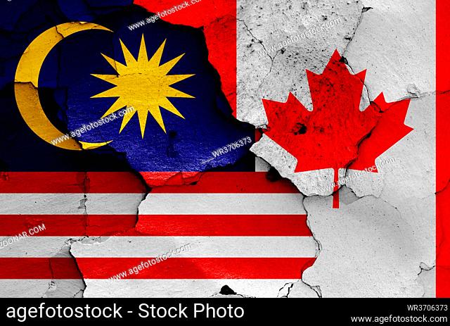 flags of Malaysia and Canada painted on cracked wall