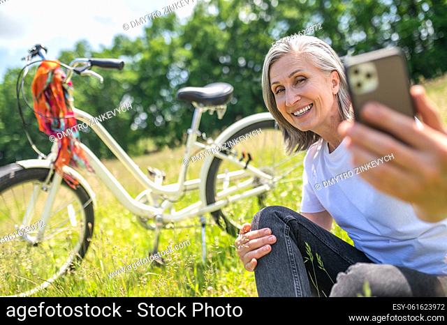 Selfie. Smiling woman making selfie on her smartphone and looking excited