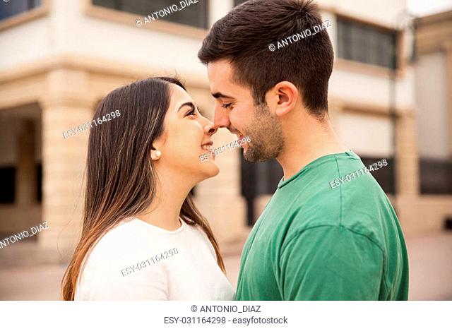 Closeup of a happy young couple standing very close to each other and about to kiss