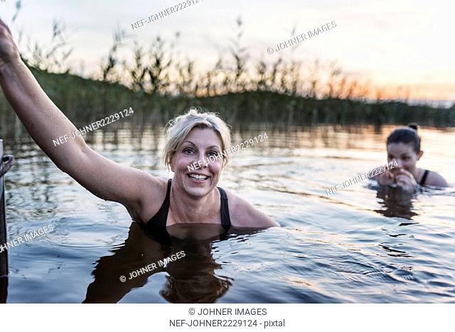 Women swimming in lake