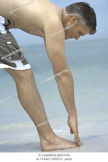 Man touching toes