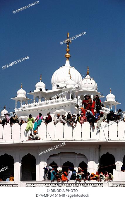 Devotees watching procession of Hola Mohalla festival from Anandpur sahib Gurudwara in Rupnagar district ; Punjab ; India