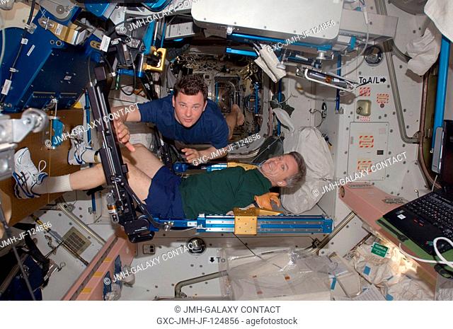 Canadian Space Agency astronaut Robert Thirsk, Expedition 20 flight engineer, exercises using the advanced Resistive Exercise Device (aRED) in the Unity node of...