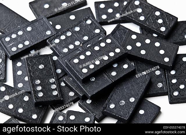 Dominoes is a board game in which rectangular tiles (tiles) are used, generally white on the face and black on the back, although there are many variants