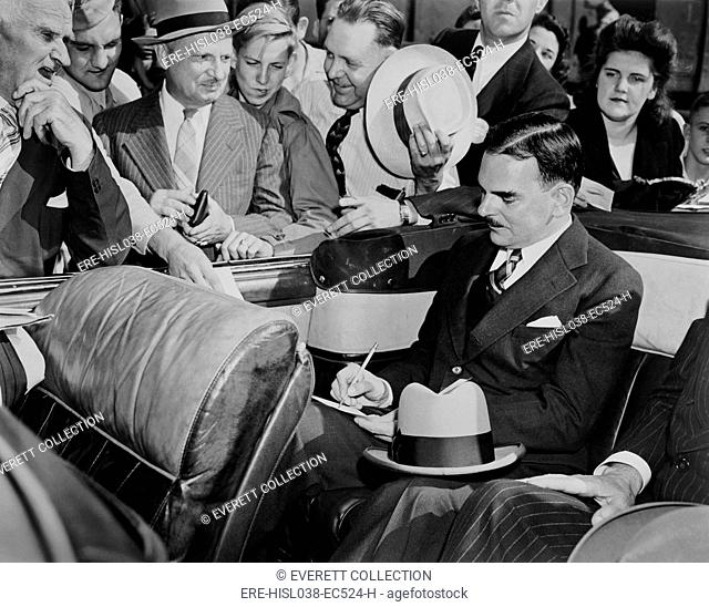Republican Presidential candidate Thomas Dewey signing autographs in Louisville, Kentucky. Sept. 11, 1944. He lost to President Franklin Roosevelt