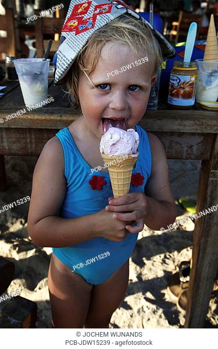 Three year old girl enjoying an icecream on holiday