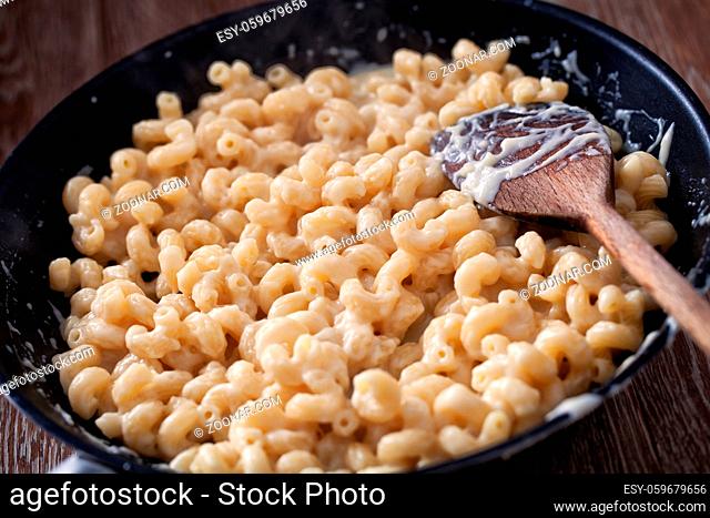 mac and cheese, macaroni pasta in cheesy sauce - American style. High quality photo