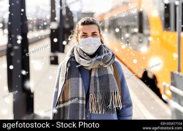 woman in protective face mask at railway station