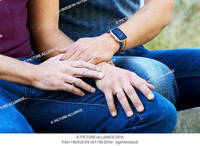 27 September 2018, Berlin: Gay couple Kai and Michael Korok wearing wedding rings and a watch with a rainbow bracelet. They married last October as one of the...