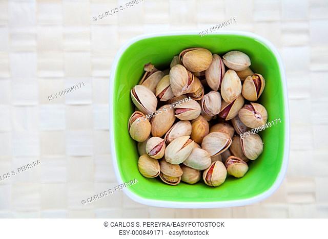 a bowl with pistachios