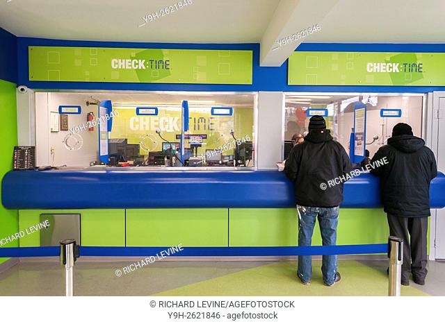 Customers in the newly remodeled branch of Check:Time in the Williamsburg neighborhood of Brooklyn in New York. The six store financial services company located...