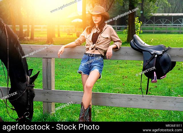 Grazing horses and leaned against the fence of the young woman with a personality
