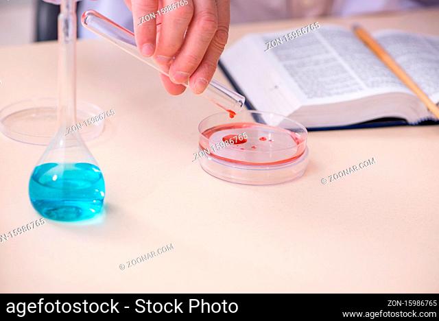 Experienced old scientist working in the laboratory