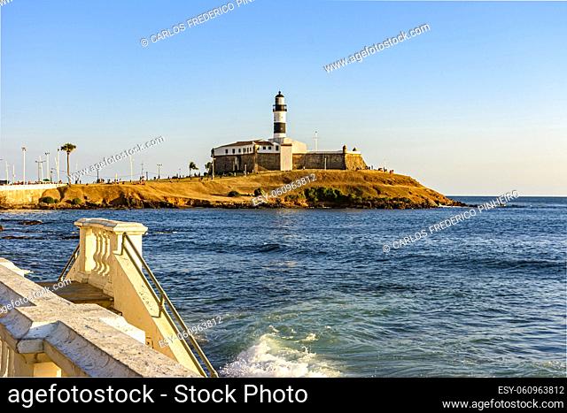 Barra Lighthouse, one of the main tourist spots in Salvador in Bahia surrounded by the sea during the late summer afternoon