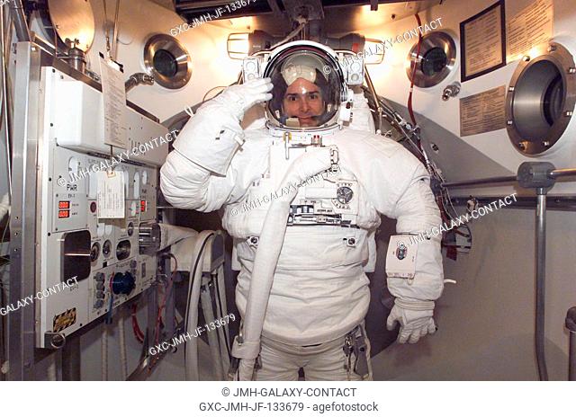 Astronaut Lee M. E. Morin, STS-110 mission specialist, is photographed during an Extravehicular Mobility Unit (EMU) fit check in a Space Station Airlock Test...