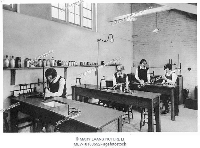 Pupils at South Hall school for Girls, at Hemel Hempstead, Hertfordshire, at work in the laboratory. The girl in the centre is using a Bunsen Burner
